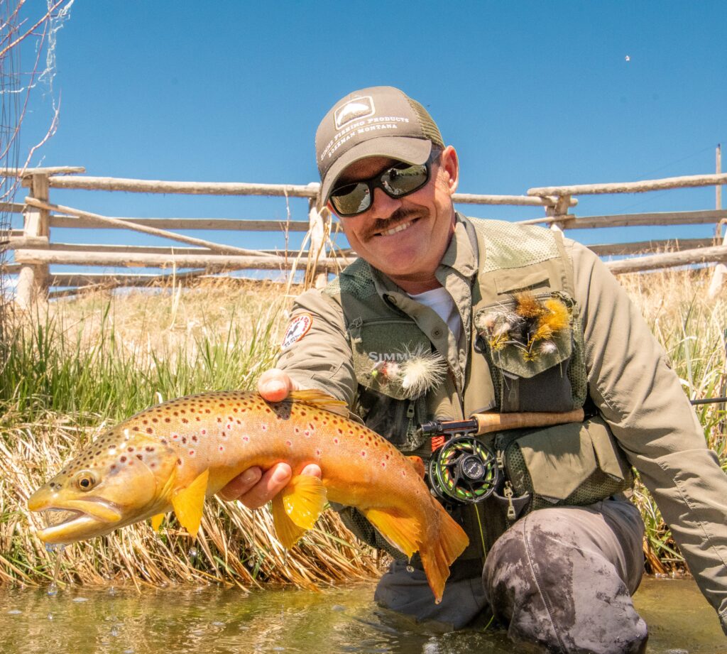 Rooster holding a brown trout